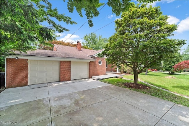 792 Miner Rd, Highland Heights, OH 44143 - view of front of home with brick siding, a front lawn, driveway, and a chimney