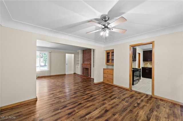 792 Miner Rd, Highland Heights, OH 44143 - empty room with light wood finished floors, a brick fireplace, and ceiling fan