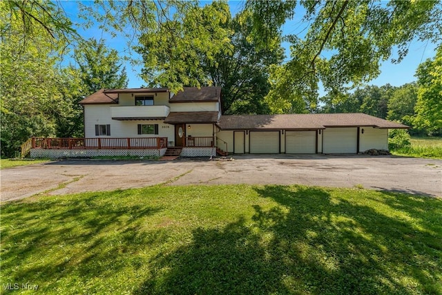 3378 State Route 164, Leetonia, OH 44431 - view of front of property with a front lawn, asphalt driveway, a garage, and a wooden deck