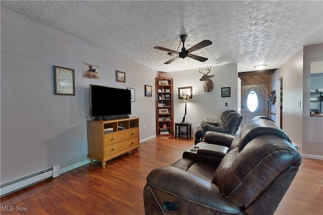 3378 State Route 164, Leetonia, OH 44431 - living area with a baseboard heating unit, ceiling fan, wood finished floors, and a textured ceiling