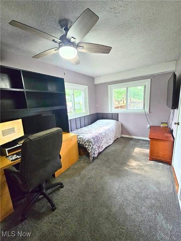 8240 Bellflower Rd, Mentor, OH 44060 - carpeted bedroom featuring a textured ceiling, an office area, and ceiling fan