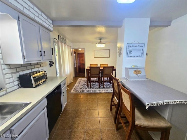 8240 Bellflower Rd, Mentor, OH 44060 - kitchen featuring dishwasher, light countertops, backsplash, and dark tile patterned floors