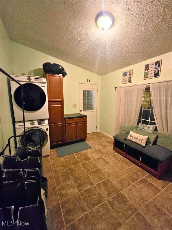 8240 Bellflower Rd, Mentor, OH 44060 - washroom with stacked washer / dryer and a textured ceiling