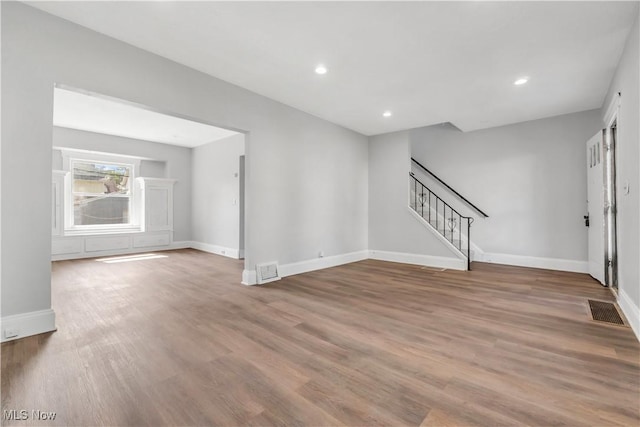 3400 W 118th St, Cleveland, OH 44111 - unfurnished living room featuring stairs, wood finished floors, and recessed lighting