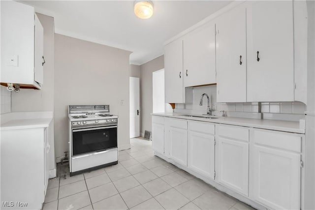 3400 W 118th St, Cleveland, OH 44111 - kitchen featuring white range, white cabinets, light countertops, and decorative backsplash