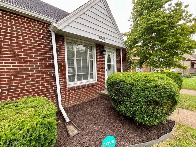 2420 Empire Rd NE, Canton, OH 44705 - view of side of property with brick siding and a shingled roof