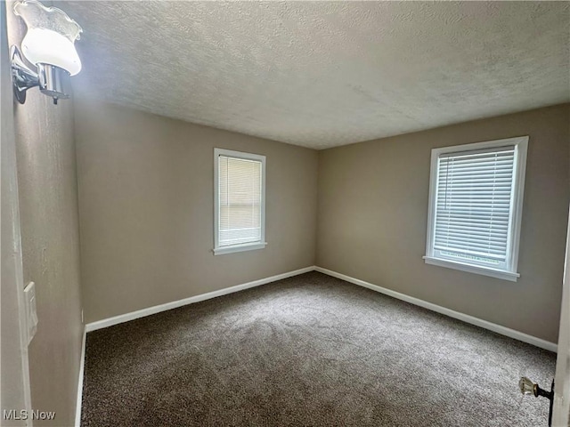 2420 Empire Rd NE, Canton, OH 44705 - unfurnished room featuring a textured ceiling and carpet
