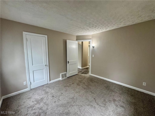 2420 Empire Rd NE, Canton, OH 44705 - unfurnished bedroom featuring a textured ceiling and carpet
