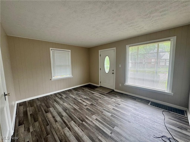 2420 Empire Rd NE, Canton, OH 44705 - foyer entrance with wood finished floors, a textured ceiling, and wooden walls