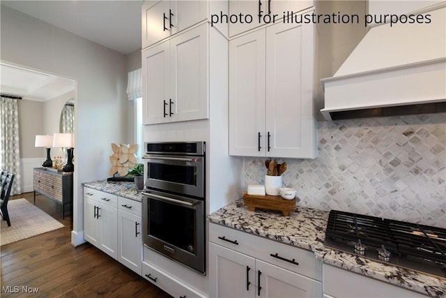 52 Boulder Blvd, Peninsula, OH 44264 - kitchen with appliances with stainless steel finishes, custom exhaust hood, dark wood-style floors, decorative backsplash, and light stone countertops