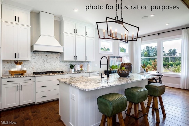 52 Boulder Blvd, Peninsula, OH 44264 - kitchen featuring custom exhaust hood, black cooktop, dark wood-style floors, decorative backsplash, and recessed lighting