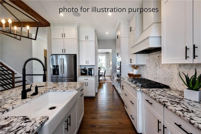 52 Boulder Blvd, Peninsula, OH 44264 - kitchen featuring appliances with stainless steel finishes, custom exhaust hood, dark wood-style floors, white cabinets, and decorative backsplash