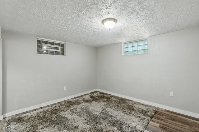 2557 Ogden Ave, Akron, OH 44312 - below grade area with wood finished floors and a textured ceiling