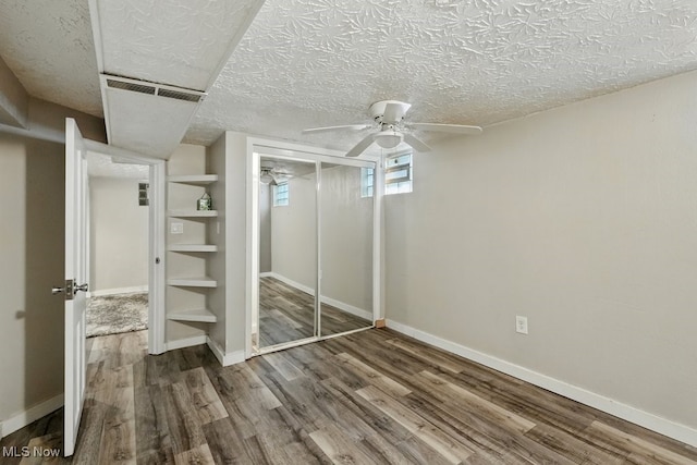2557 Ogden Ave, Akron, OH 44312 - unfurnished bedroom featuring wood finished floors, a closet, a textured ceiling, and a ceiling fan