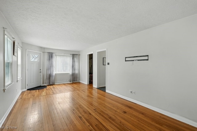 2557 Ogden Ave, Akron, OH 44312 - foyer entrance with hardwood / wood-style floors and a textured ceiling
