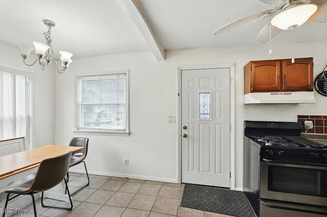 2557 Ogden Ave, Akron, OH 44312 - kitchen featuring stainless steel gas stove, under cabinet range hood, light tile patterned flooring, a chandelier, and ceiling fan