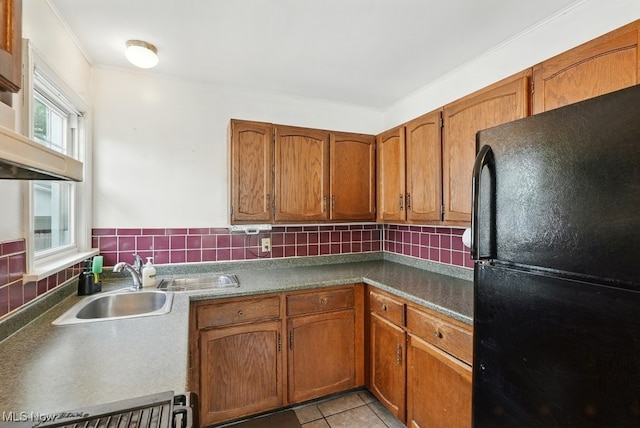 2557 Ogden Ave, Akron, OH 44312 - kitchen with freestanding refrigerator, brown cabinetry, tasteful backsplash, light tile patterned flooring, and ornamental molding
