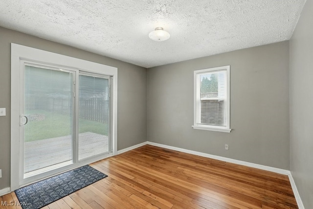 2557 Ogden Ave, Akron, OH 44312 - empty room featuring wood-type flooring and a textured ceiling