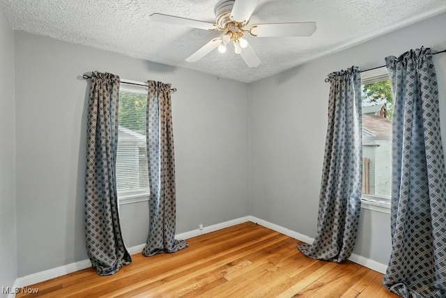 2557 Ogden Ave, Akron, OH 44312 - spare room featuring wood finished floors, a textured ceiling, healthy amount of natural light, and ceiling fan