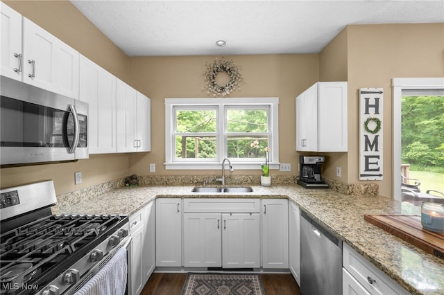 12230 Country Oaks Trl, Chardon, OH 44024 - kitchen featuring appliances with stainless steel finishes, healthy amount of natural light, and dark wood-type flooring