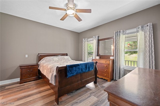 12230 Country Oaks Trl, Chardon, OH 44024 - bedroom featuring light wood-style flooring, multiple windows, and a ceiling fan