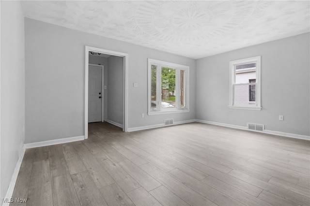 922 Winton Ave, Akron, OH 44320 - spare room featuring wood finished floors and a textured ceiling