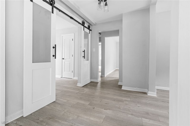 922 Winton Ave, Akron, OH 44320 - hall featuring a barn door and light wood finished floors