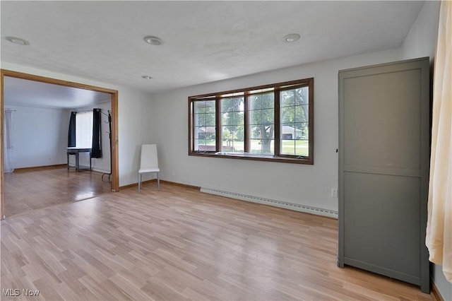 374 Glendola Ave NW, Warren, OH 44483 - empty room with a baseboard radiator and light wood-style flooring