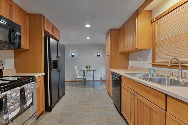 374 Glendola Ave NW, Warren, OH 44483 - kitchen featuring black appliances, light countertops, recessed lighting, and brown cabinets