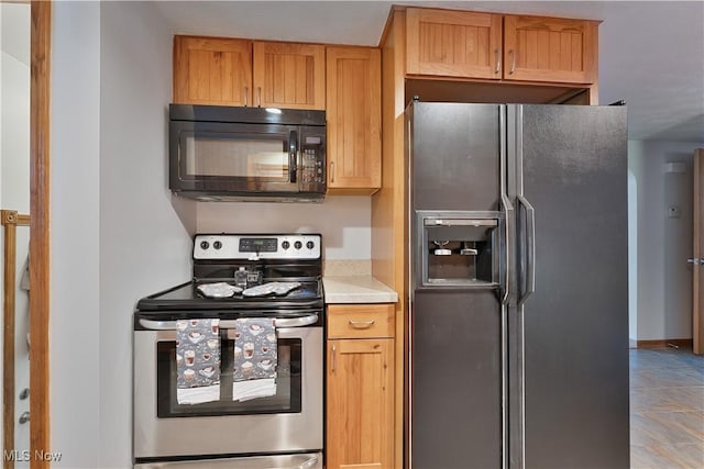 374 Glendola Ave NW, Warren, OH 44483 - kitchen featuring fridge with ice dispenser, black microwave, stainless steel electric range, and light countertops