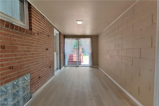 374 Glendola Ave NW, Warren, OH 44483 - hallway featuring wood finished floors and brick wall