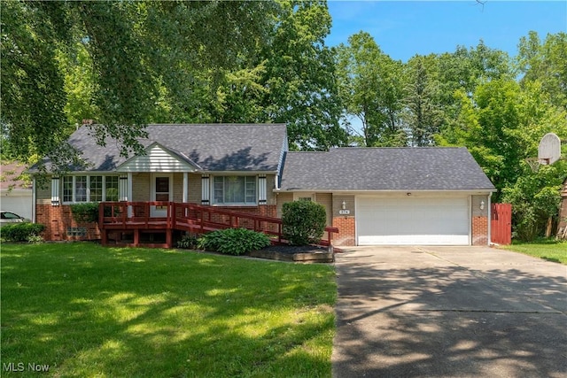 374 Glendola Ave NW, Warren, OH 44483 - view of front of home with brick siding, a front yard, driveway, and an attached garage