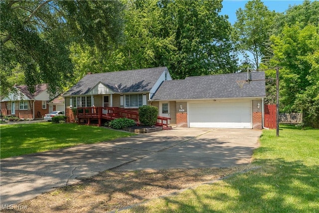 374 Glendola Ave NW, Warren, OH 44483 - view of front of property with brick siding, driveway, an attached garage, and a front yard