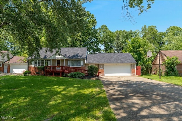 374 Glendola Ave NW, Warren, OH 44483 - view of front of house featuring brick siding, concrete driveway, a front yard, and a garage