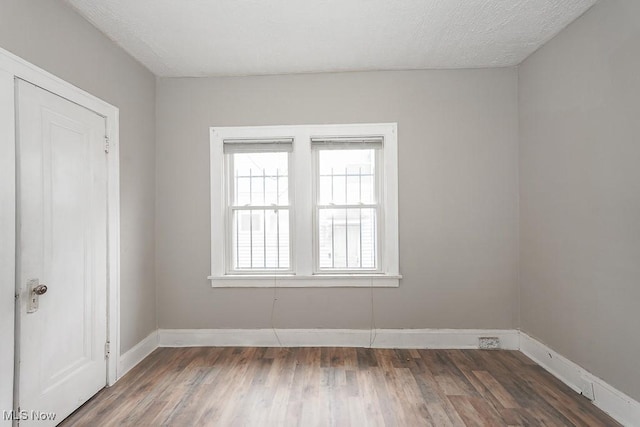 3569 E 154th St, Cleveland, OH 44120 - unfurnished room featuring wood finished floors and a textured ceiling