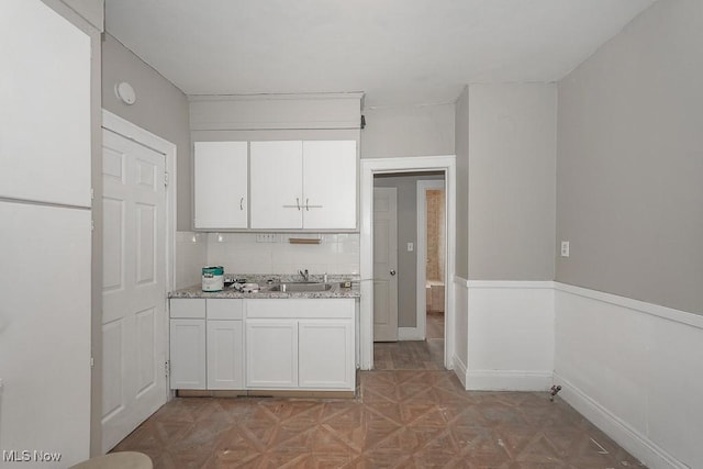 3569 E 154th St, Cleveland, OH 44120 - kitchen with white cabinetry and backsplash