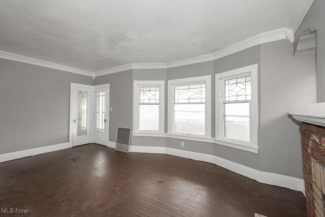 3569 E 154th St, Cleveland, OH 44120 - unfurnished living room with ornamental molding, plenty of natural light, wood-type flooring, and a fireplace