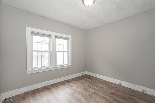 3569 E 154th St, Cleveland, OH 44120 - unfurnished room with dark wood-style flooring and a textured ceiling