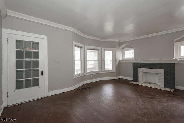 3569 E 154th St, Cleveland, OH 44120 - unfurnished living room featuring hardwood / wood-style floors, a fireplace, ornamental molding, and arched walkways