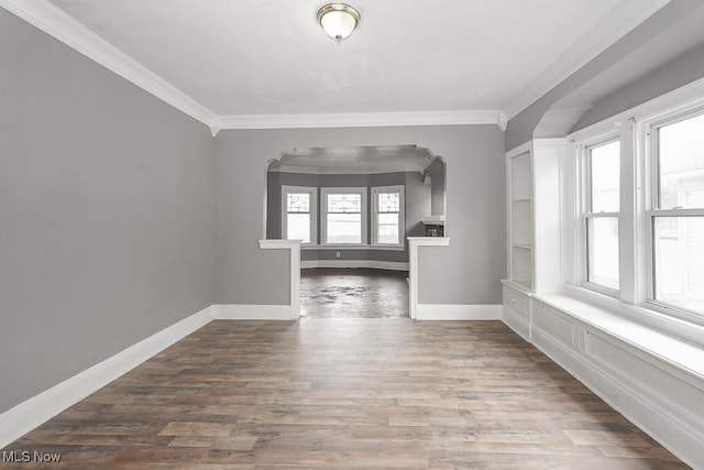 3569 E 154th St, Cleveland, OH 44120 - spare room featuring arched walkways, ornamental molding, and wood finished floors