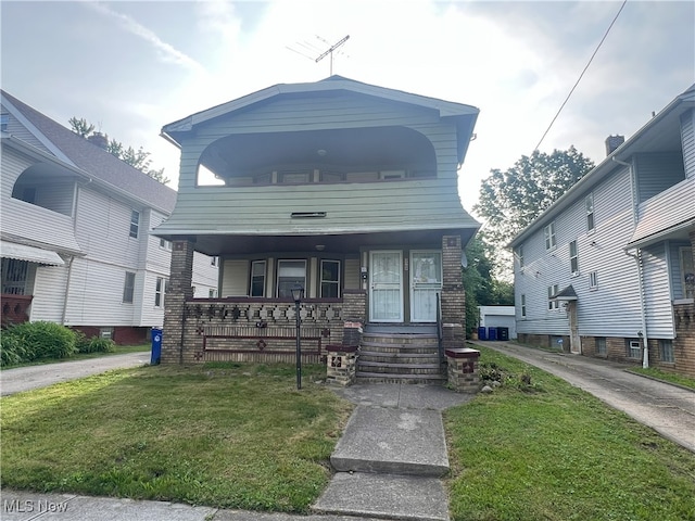 3569 E 154th St, Cleveland, OH 44120 - view of front of house with a porch and a front yard