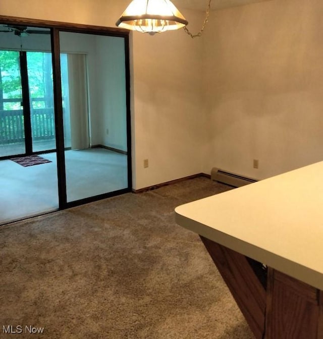 2197 Pinebrook Trl, Cuyahoga Falls, OH 44223 - empty room featuring dark carpet, a baseboard heating unit, and ceiling fan