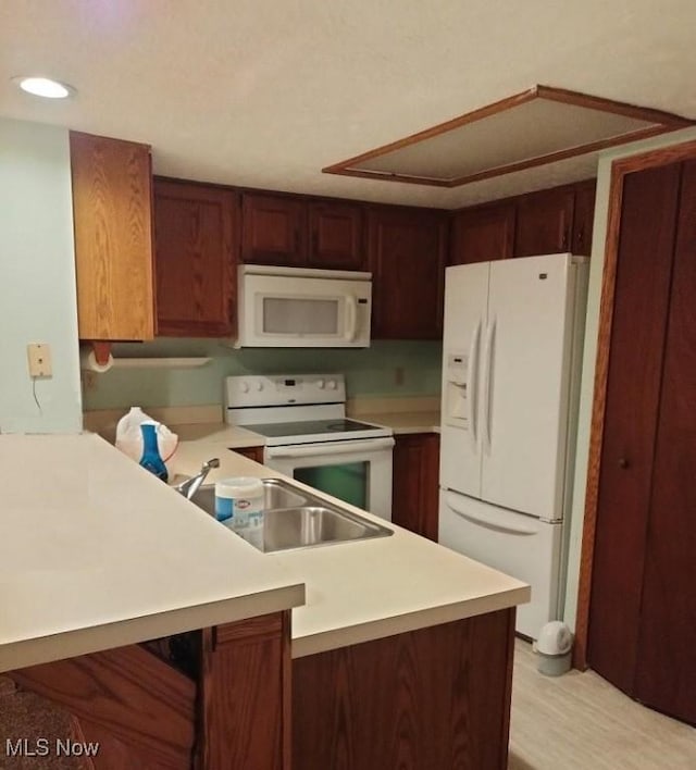 2197 Pinebrook Trl, Cuyahoga Falls, OH 44223 - kitchen with white appliances, a peninsula, light countertops, recessed lighting, and light wood-type flooring