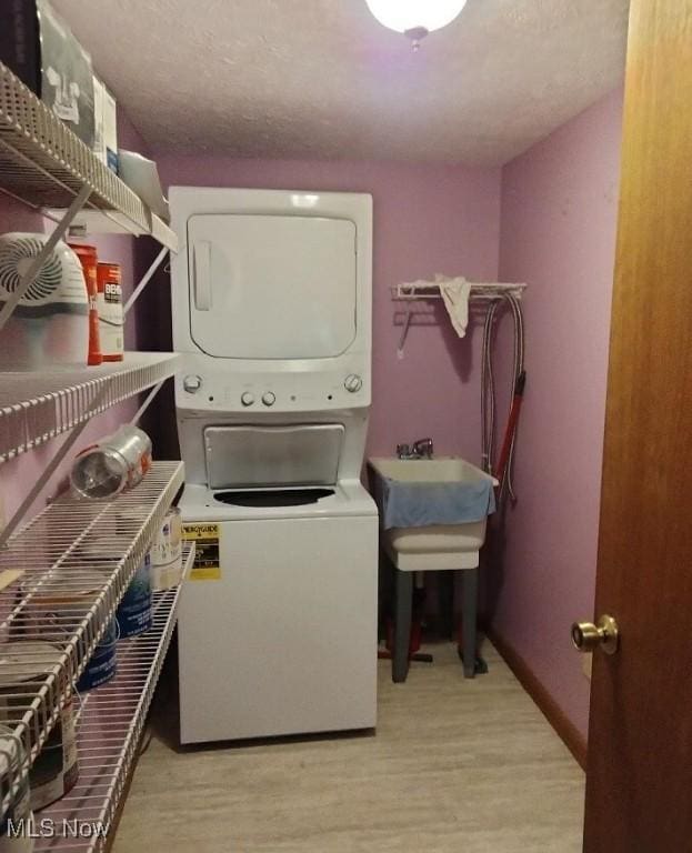 2197 Pinebrook Trl, Cuyahoga Falls, OH 44223 - washroom featuring stacked washer / dryer and wood finished floors