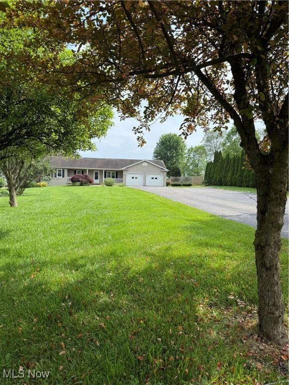 2359 Schellin Rd, Wooster, OH 44691 - view of front of property with a garage, concrete driveway, and a front yard