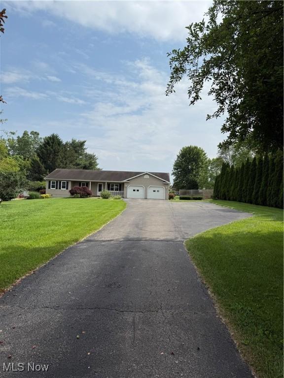 2359 Schellin Rd, Wooster, OH 44691 - ranch-style home featuring asphalt driveway, a garage, and a front yard
