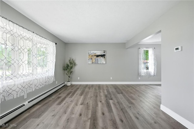 5417 Edgewood Dr, Lorain, OH 44053 - spare room featuring baseboard heating and wood finished floors
