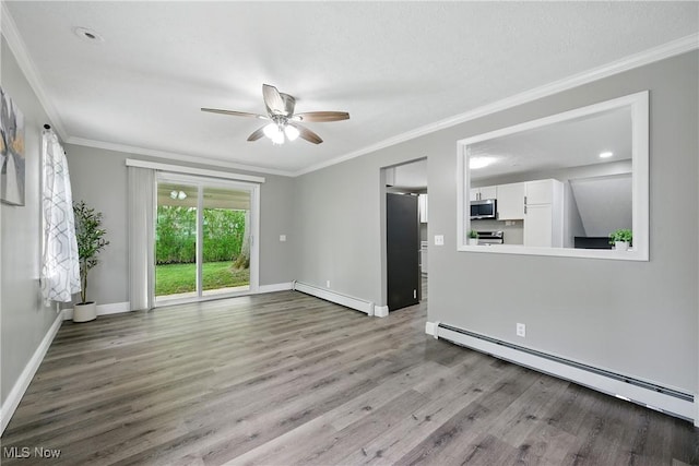 5417 Edgewood Dr, Lorain, OH 44053 - unfurnished room with a baseboard heating unit, a baseboard radiator, wood finished floors, ornamental molding, and a ceiling fan