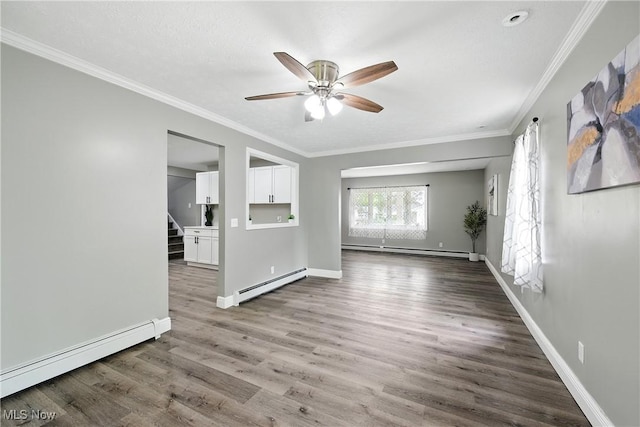 5417 Edgewood Dr, Lorain, OH 44053 - empty room with a baseboard heating unit, a baseboard radiator, a ceiling fan, stairway, and ornamental molding