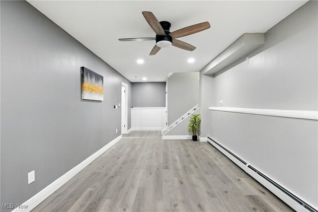 5417 Edgewood Dr, Lorain, OH 44053 - corridor featuring baseboard heating, wood finished floors, recessed lighting, and stairway